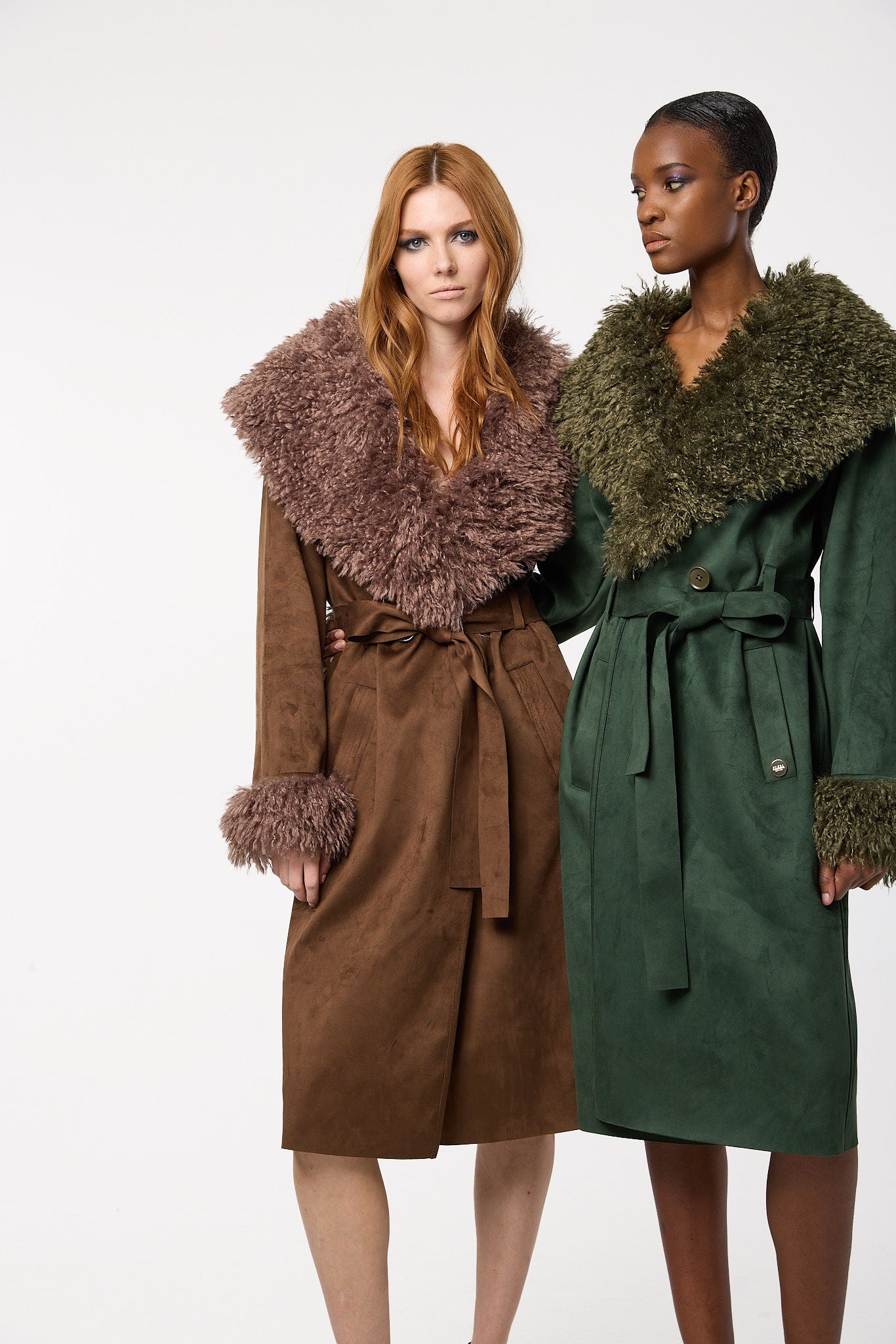 Editorial shot — KENZIE in Pecan styled alongside a model in the autumn-tone Fern colourway, highlighting the coat’s dramatic texture and rich tonal warmth.