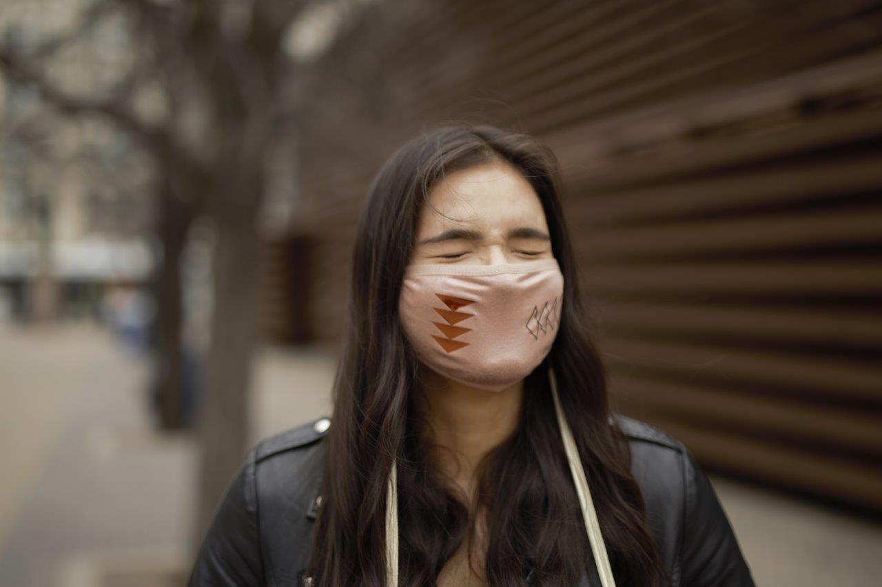 Made in Canada beige adult breathable face mask with Indigenous design.