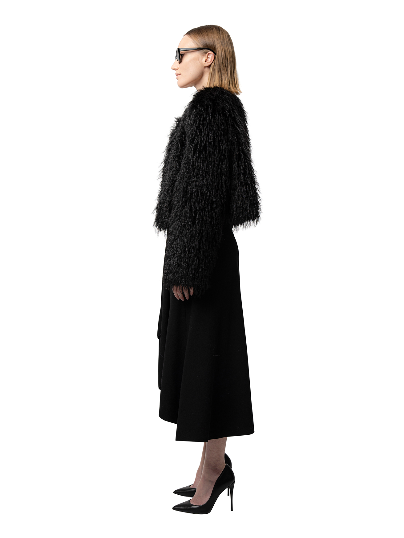 ANNA jacket in Carbon — side profile showing short hemline, cruelty-free faux fur texture, and slit pocket detail.
