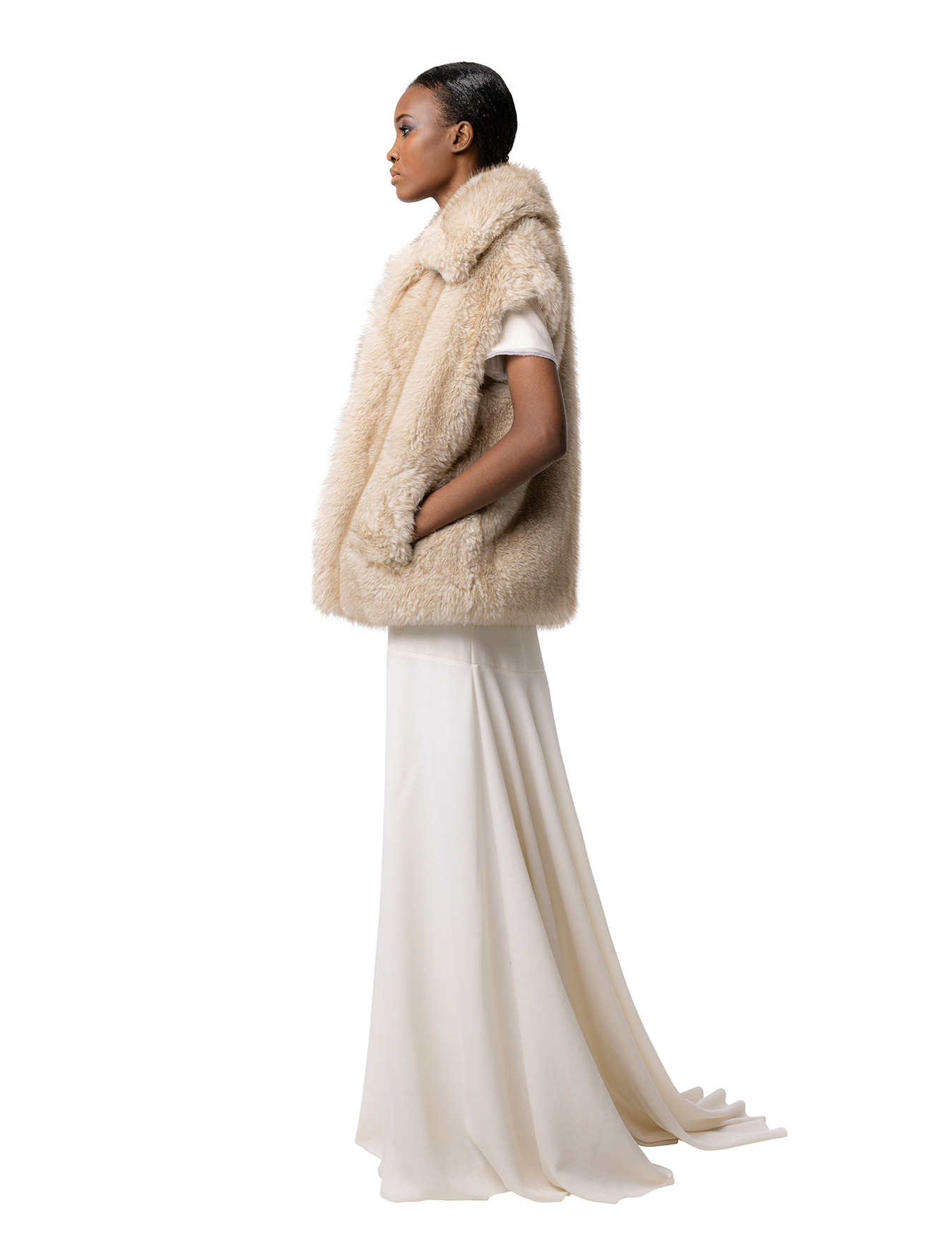 Side view — MIA coat in Fox, beige faux fur outerwear shown from the side, with relaxed drape and structured yet soft shape.