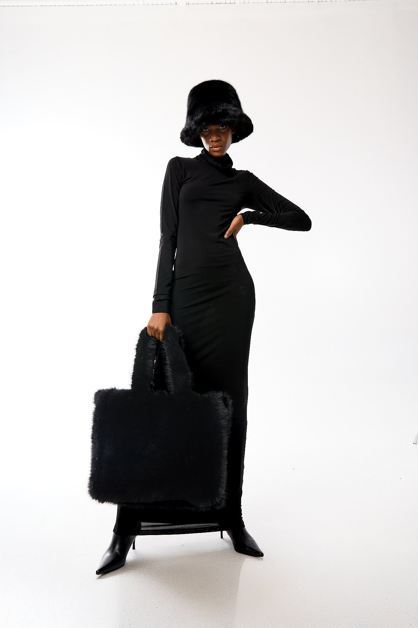 Editorial shot — Oversized Tote in Ink Black styled on a model, showcasing its versatile black colour and plush texture.

