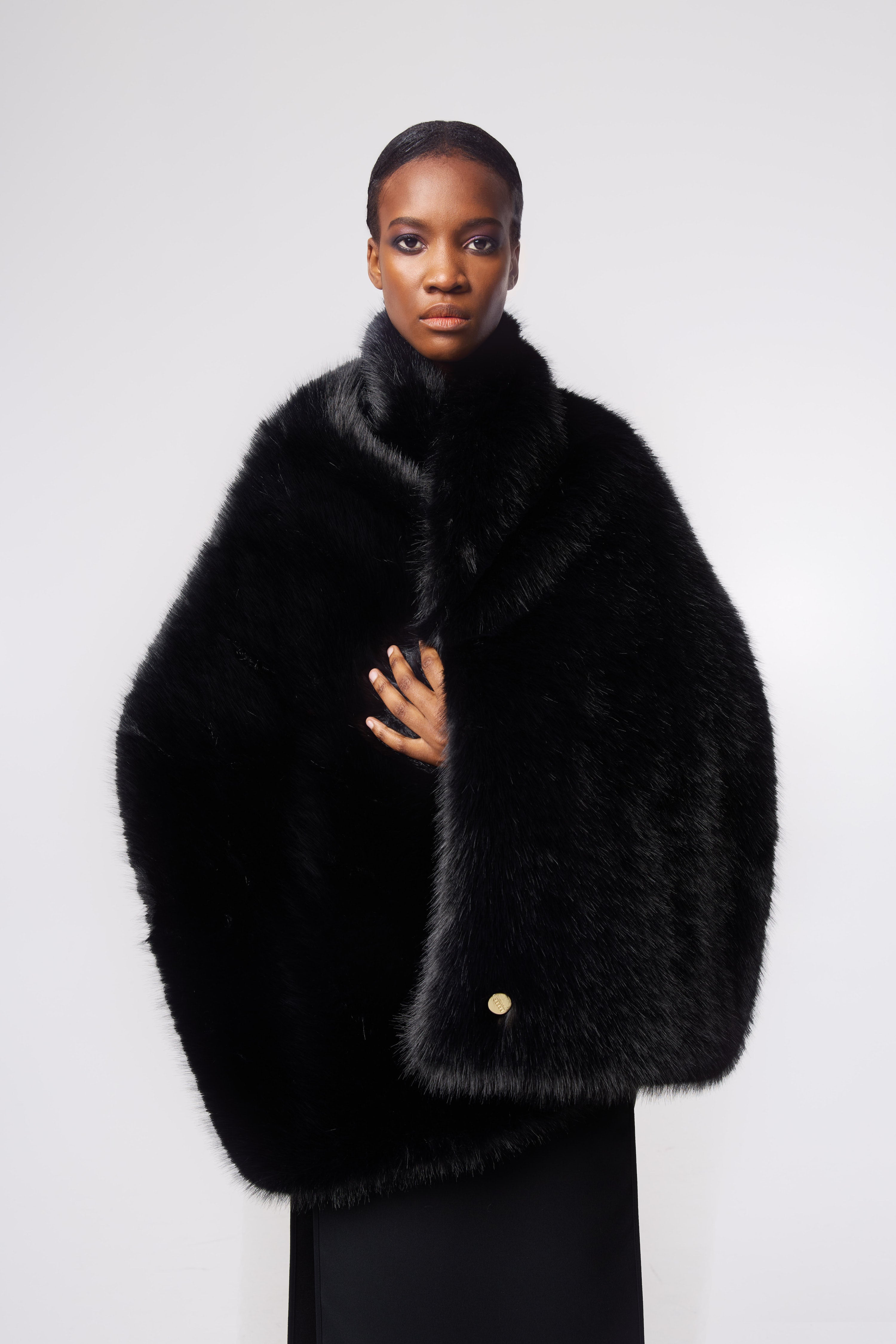 Editorial shot — Wrap Scarf in Ink Black styled on a model, showcasing its voluminous drape and versatile styling options.