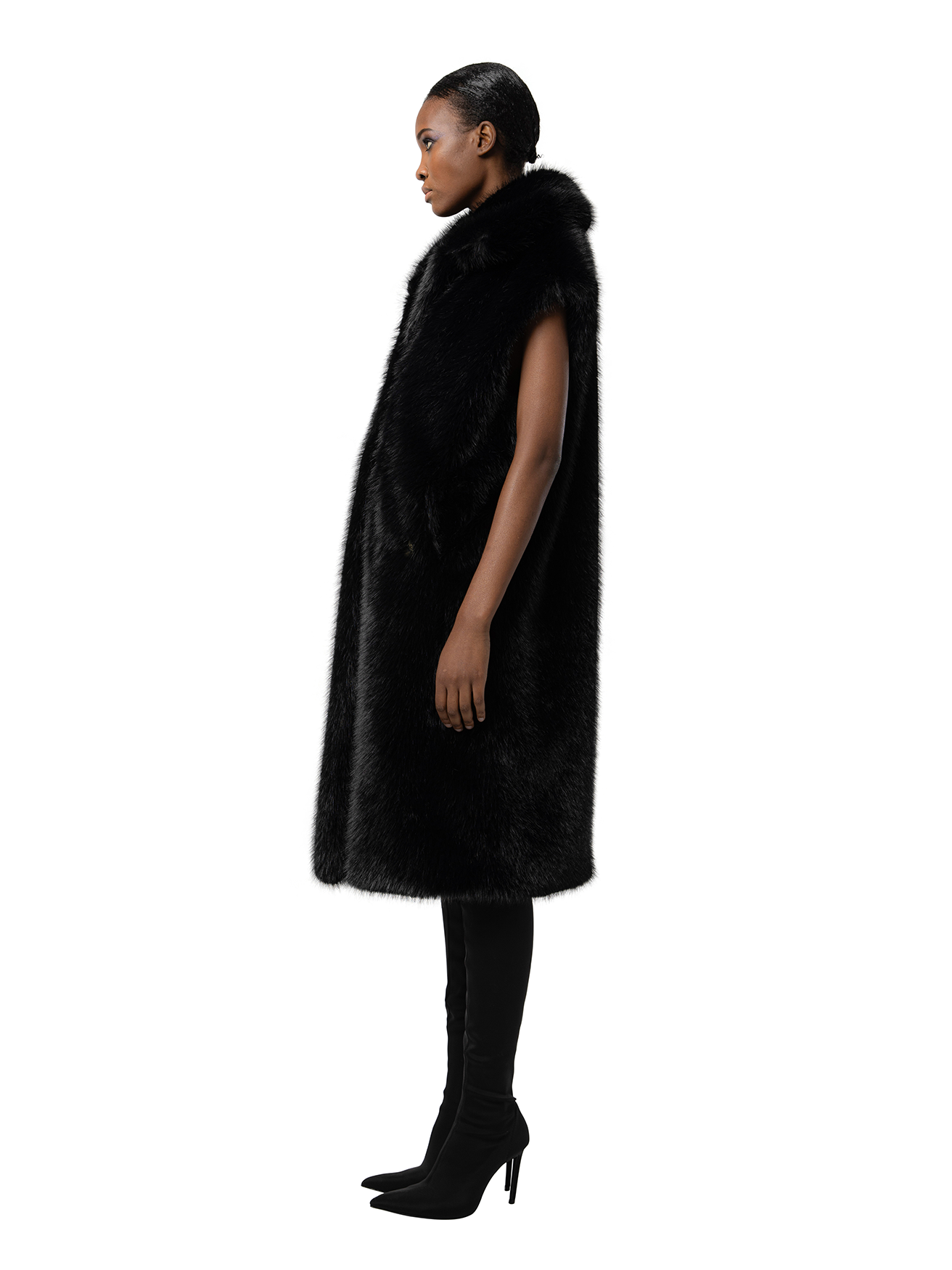 Side view — KIT in Ink Black shown from the side, highlighting the plush cruelty-free faux fur and clean lines of the relaxed fit.