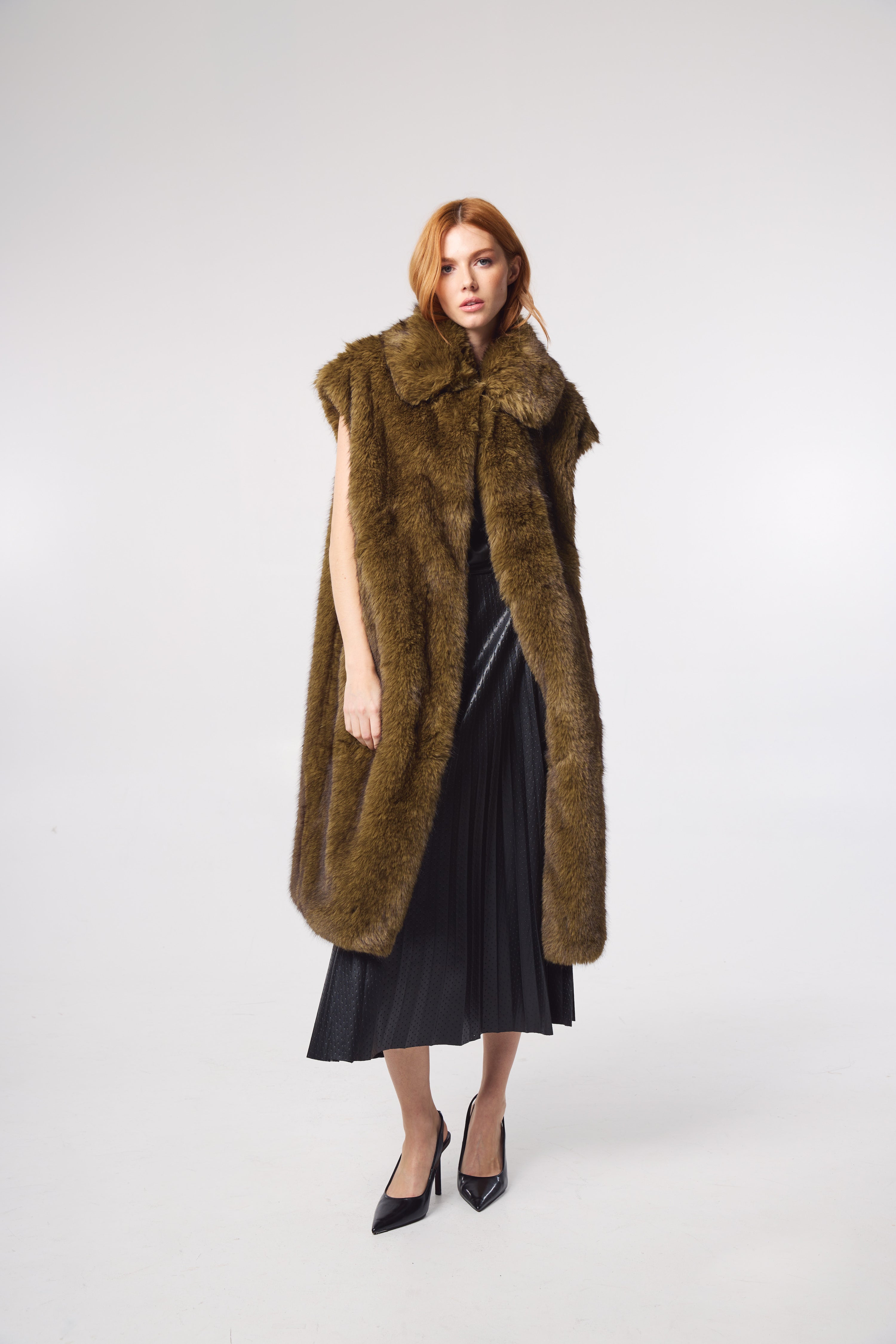 Editorial shot — KIT in Olive styled editorially, layered with earth tones to accentuate the coat’s rich colour and luxurious faux fur texture.