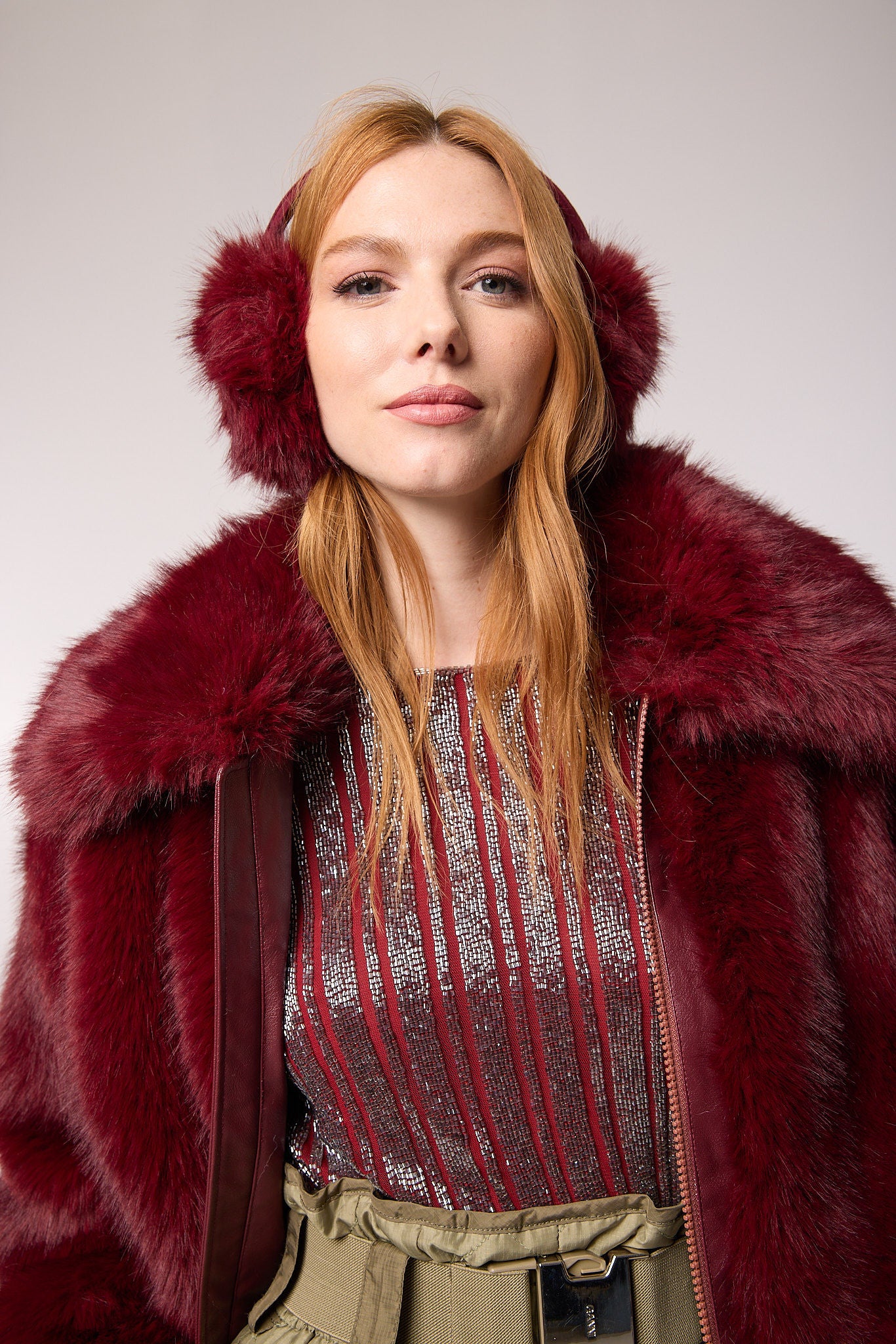 Editorial shot — Ear Muffs in Merlot worn by a model, highlighting the rich colour and cozy texture as a stylish winter accessory.