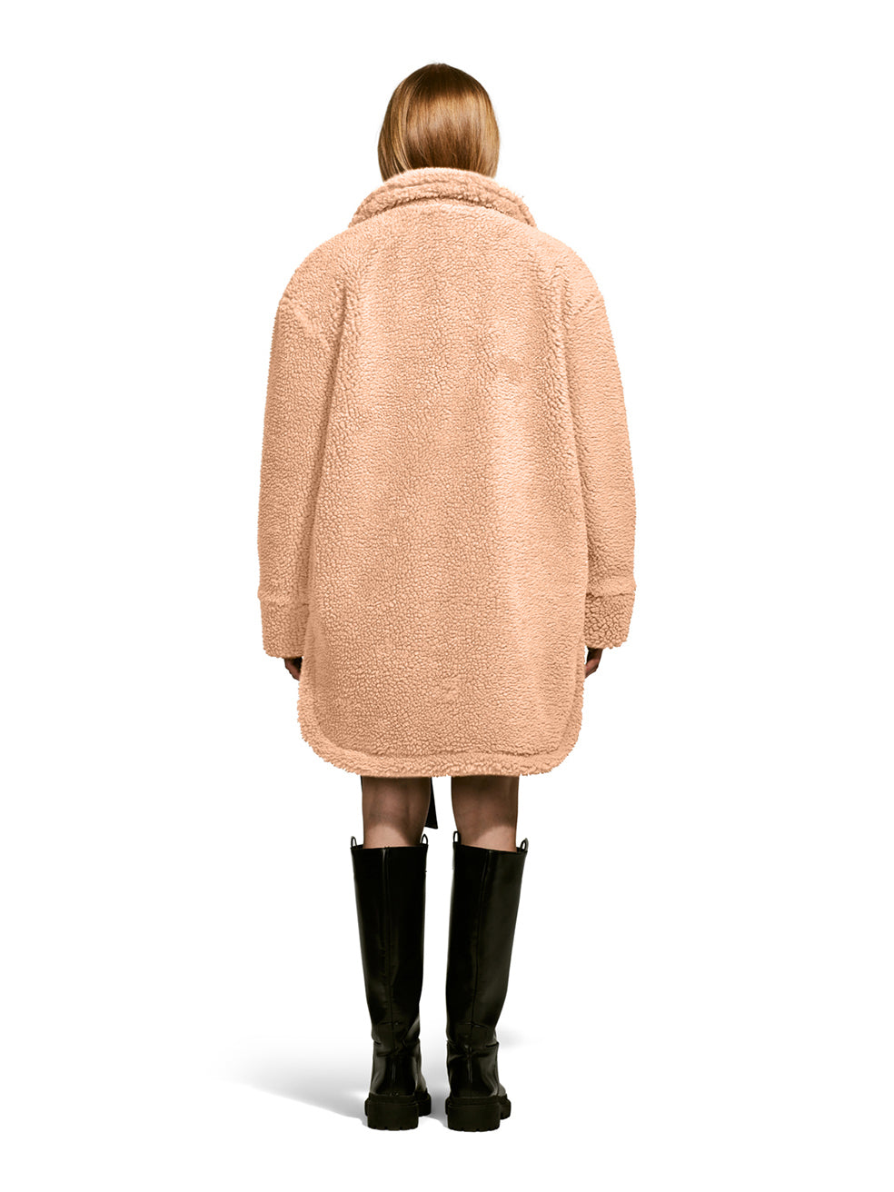 Model wearing the Ash, a teddy-inspired faux-fur sherpa shell with a laid-back silhouette in Camel from the rear.