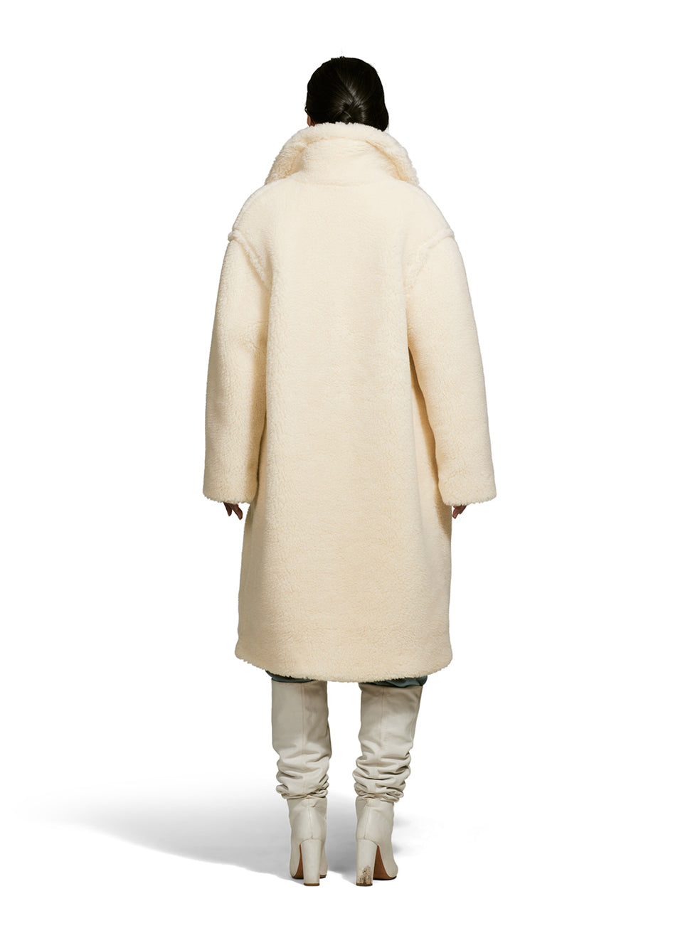 Female model wearing a teddy-inspired faux-fur sherpa shell in cream color on a white background from the back.