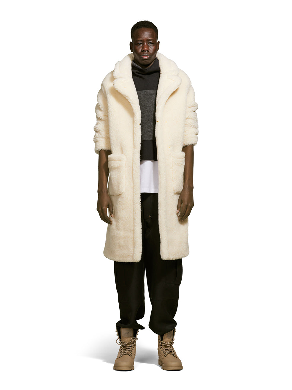 Model wearing a teddy-inspired faux-fur sherpa shell in cream color on a white background from the front.